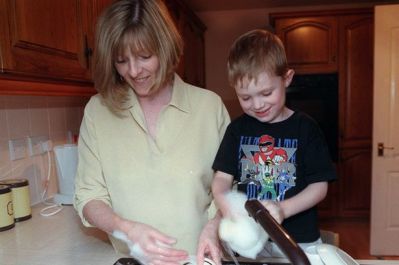 a-son-helping-his-mother-wash-up-dishes